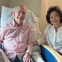 Senator_Mitch_McConnell_in_hospital_bed_beside_former_Transportation_Secretary_Elaine_Chao