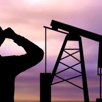 Oil Worker and Oil Rig - Shutterstock