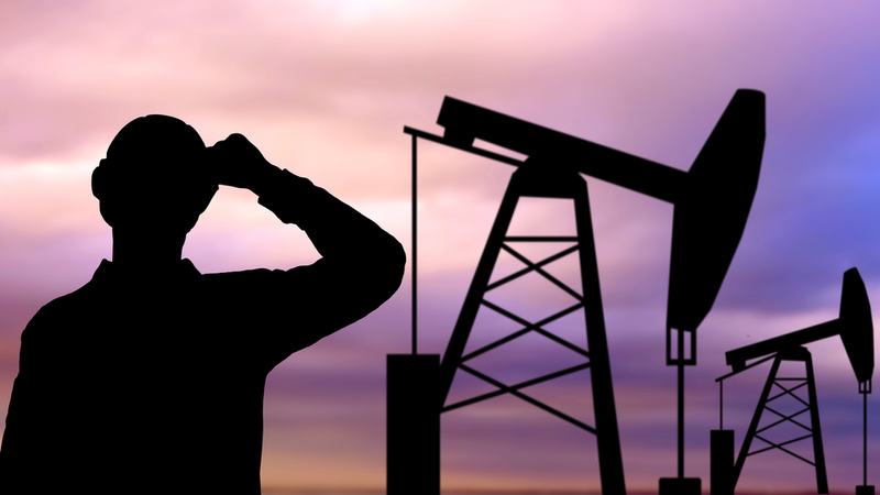 Oil Worker and Oil Rig - Shutterstock